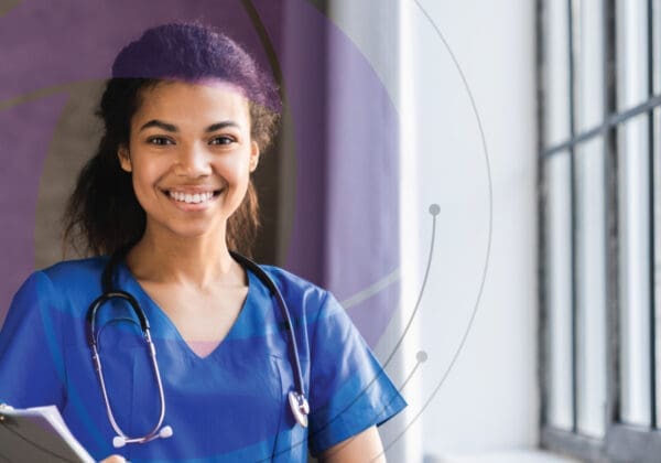 Nurse standing with stethoscope around neck and tablet